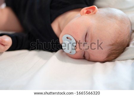 Similar – Baby asleep while parents caress