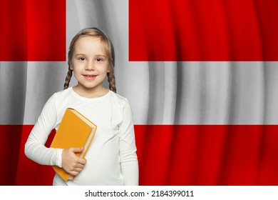 Kid With Book Against Danish Flag Background. Education And School In Denmark Concept