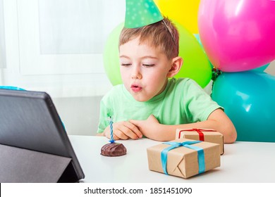 Kid Boy 5-6 Years Celebrates Birthday During Quarantine. Virtual Birthday Party Online With Friend Or Grandparents. Video Call On Tablet. Social Distance, Stay Home, Self-isolation. Selective Focus