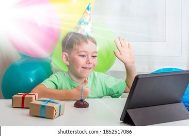 Kid Boy 5-6 Years Celebrates Birthday During Quarantine. Virtual Birthday Party Online With Friend Or Grandparents. Video Call On Tablet. Social Distance, Stay Home, Self-isolation. Selective Focus