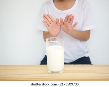 Kid Boy Feels Bad, Has An Upset Stomach, Bloating Due To Lactose Intolerance. Dairy Intolerant Person. Milk Product Concept.