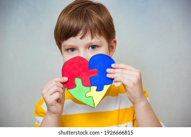 Kid Boy Hands Holding Puzzle Heart, Child Mental Health Concept, World Autism Awareness Day, Teen Autism Spectrum Disorder Awareness Concept