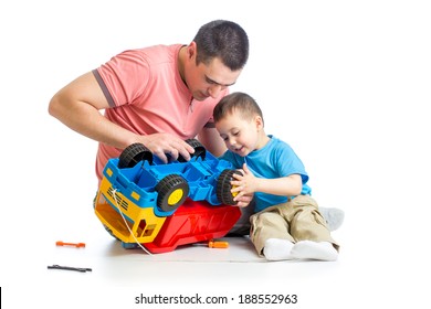 kid boy and his dad repair toy trunk