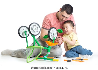 Kid Boy And His Daddy Fixing Children Bike