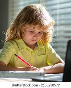 Kid Boy At Home Writes Draws, Classes For A Child At Home. Homeschool School Boy Doing Homework And Learning At Class. Child Hold A Pencil And Draw At Home. Schoolboy Teen Drawing Sitting At Table.