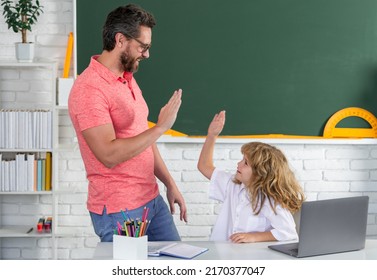 Kid Boy Learning With Teacher. Funny Little Boy Study With Father In Class On Blackboard. Pupil Of Primary Elementary School Has Lesson. Kid Boy With Teacher Learn English Language Or Mathematics.