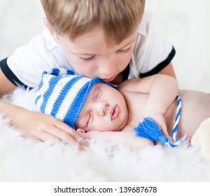 Kid Boy Looking At Sleeping Newborn Baby Brother