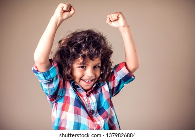 Kid boy rejoice at something. People, emotions and childhood lifestyle concept. - Shutterstock ID 1379826884