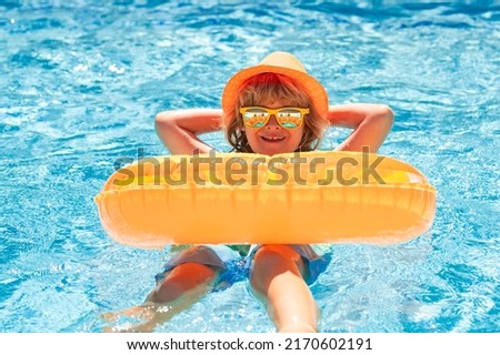 Kid boy relaxing in pool. Child swimming in water pool. Summer kids activity, watersports. Summer vacation with children. Child enjoying summer in the water in the swimmingpool.