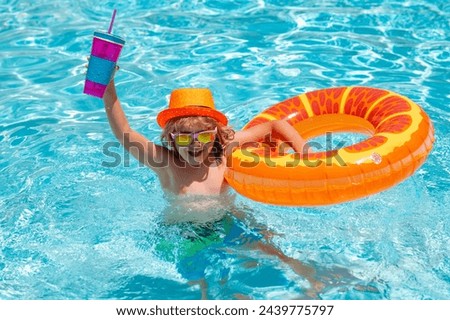 Kid boy relaxing in pool. Summer kids cocktail. Child swimming in water pool. Summer kids activity, watersports. Summer vacation with children. Child enjoying summer in the water in the swimmingpool.
