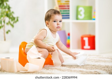 Kid Boy Sitting On Chamber Pot With Toilet Paper Roll