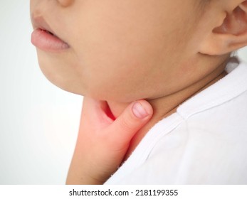 Kid Boy With Sore Throat Touching Her Neck, Feeling Pain In His Throat Caused By Tonsillitis. Closeup Photo, Blurred.