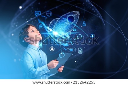 Kid boy using digital tablet, blue hud with rocket launch and different icons, social media and network connection. Concept of future opportunities and education