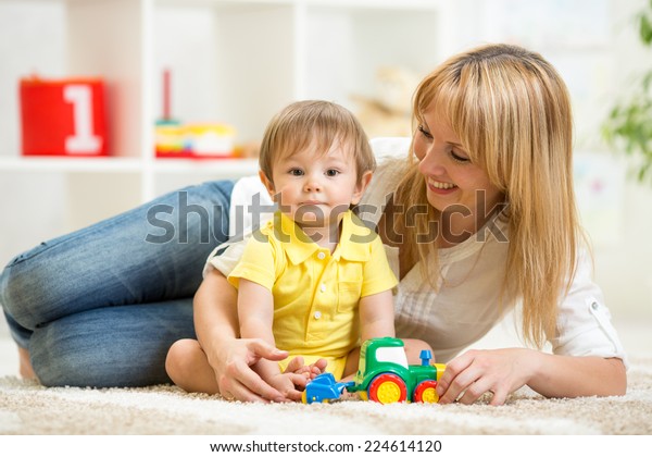 kid boy and woman\
playing with toy indoor