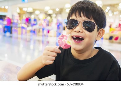 Kid With Broken Teeth Is Eating Donuts Happily