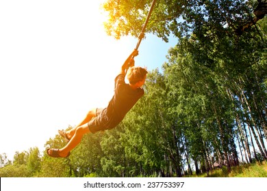 Kid Bungee jumping in the Summer Forest