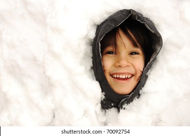 Kid Buried In Snow Smiling, Only Face Appearing