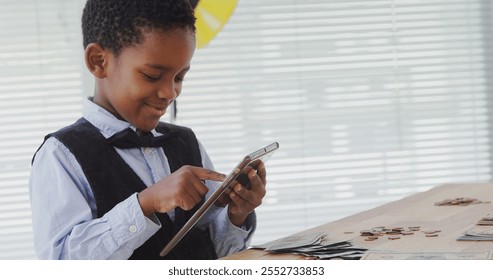 Kid as business executive using digital tablet in office - Powered by Shutterstock