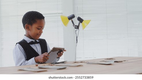 Kid as business executive using digital tablet in office - Powered by Shutterstock