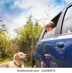 Kid In The Car And Dog Outside Look At Each Other