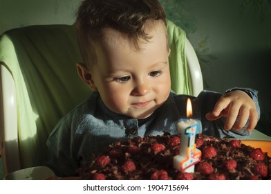 Kid Celebrates His First Birthday. Kid's Birthday, Cake With Candle. Little Boy Enjoying Cake.Smiling Child
