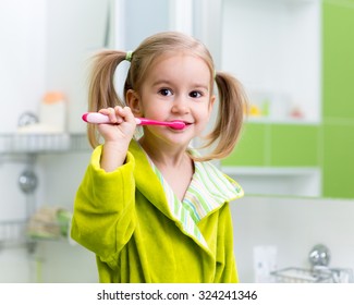 Kid Child Little Girl Brushing Teeth In Bathroom