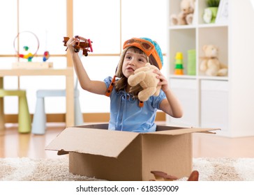 Kid child pilot flying a cardboard box in kid room
