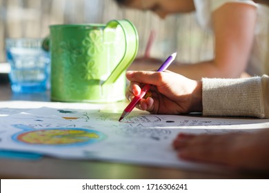 Kid is coloring the table in cafe  Close up hand 