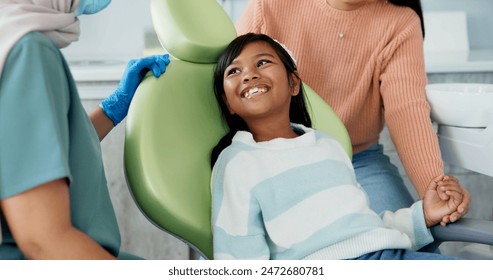 Kid, dentist and appointment for teeth or oral health education for prevention on tooth decay or hygiene. Little girl, mom and together for dentistry checkup or dental examination with orthodontist. - Powered by Shutterstock