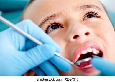 Kid at the dentist getting his teeth checked - Powered by Shutterstock