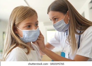 Kid At Doctor's Office With Protection Face Mask Having Temperature Checked