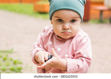 The Kid Does Not Want To Share Toys With Friends. Angry Expression And Squeezes A Toy In His Hand