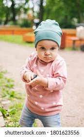 The Kid Does Not Want To Share Toys With Friends. Angry Expression And Squeezes A Toy In His Hand