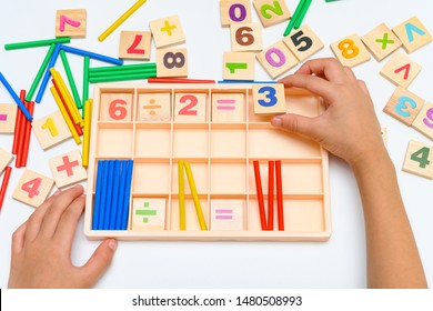 Kid Doing Division Equation Using Counting Rods