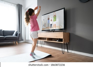 Kid Doing Online TV Fitness Exercise At Home