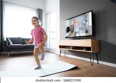 Kid Doing Online TV Fitness Exercise At Home