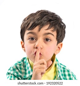 Kid doing silence gesture over white background 