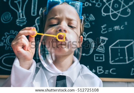 Similar – Happy kid looking at camera through magnifying glass