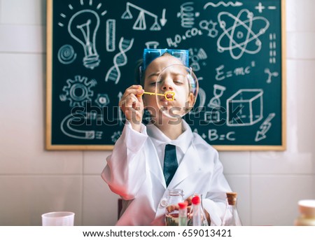 Similar – Image, Stock Photo Little scientist laughing behind of table with experiment elements