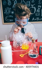 Kid Doing Soap Bubbles With Straw In Glass