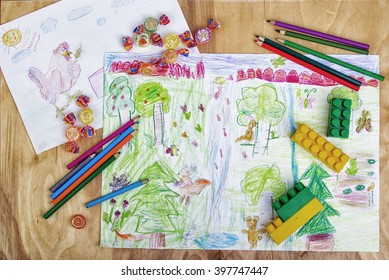 kid drawing with the paint and brushes on the table - Shutterstock ID 397747447