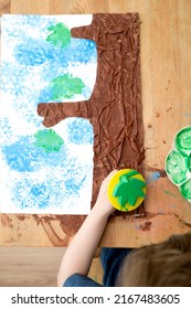 Kid Draws A Large Tree In Gouache. Children Activities, Easy Ideas At Home. Art Lessons On The Theme Of Spring. DIY Tasks For Children. Early Education.