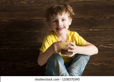 The Kid Drinking Cocoa At Home.