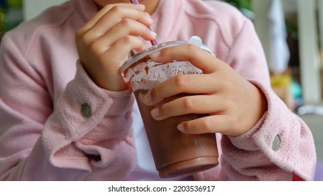 The Kid Drinking Cocoa At Park