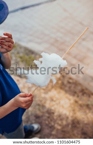 Image, Stock Photo Girl plucks off a piece of cotton candy