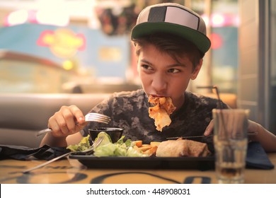 Kid Eating At A Fast Food Restaurant