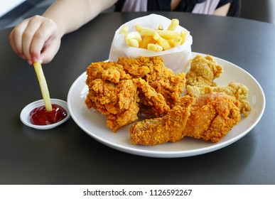 Kid Eating French Fried  And Fries Chicken / Children With Junk Food Concept