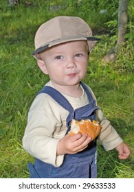 Kid Eating The Roll In The Park Outdoor