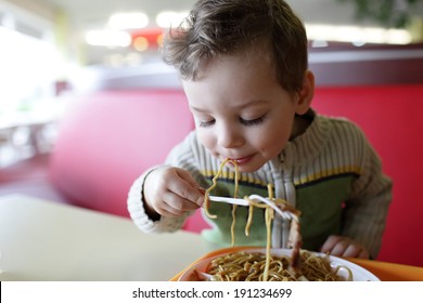 The Kid Eating Spaghetti In The Restaurant