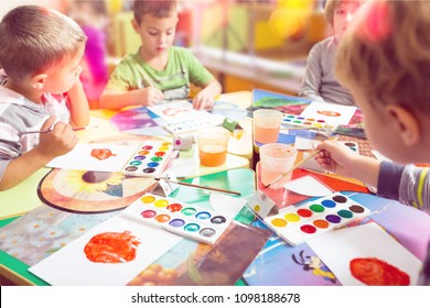 kid enjoying his painting hand